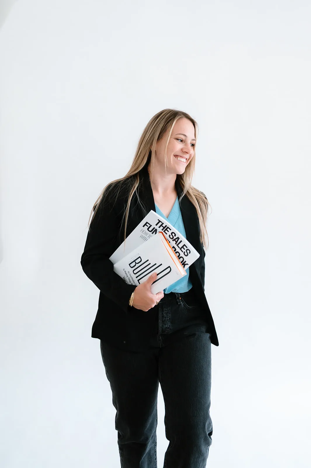 Brooke Kennison holding The Sales Funnel Book and smiling