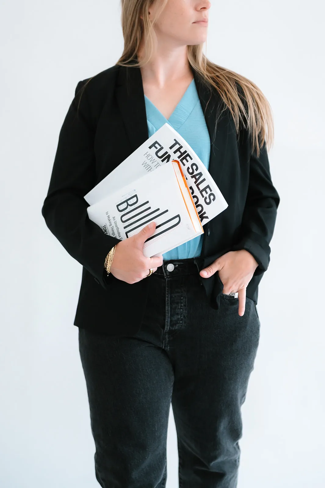 Brooke Kennison holding The Sales Funnel Book in the At The Meridian studio