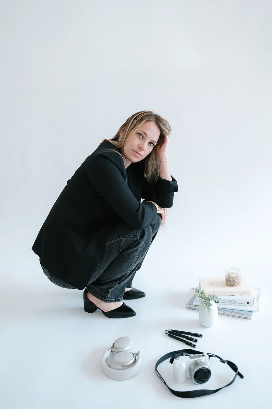 Brooke Kennison, founder of At The Meridian, in the studio with her laptop and camera