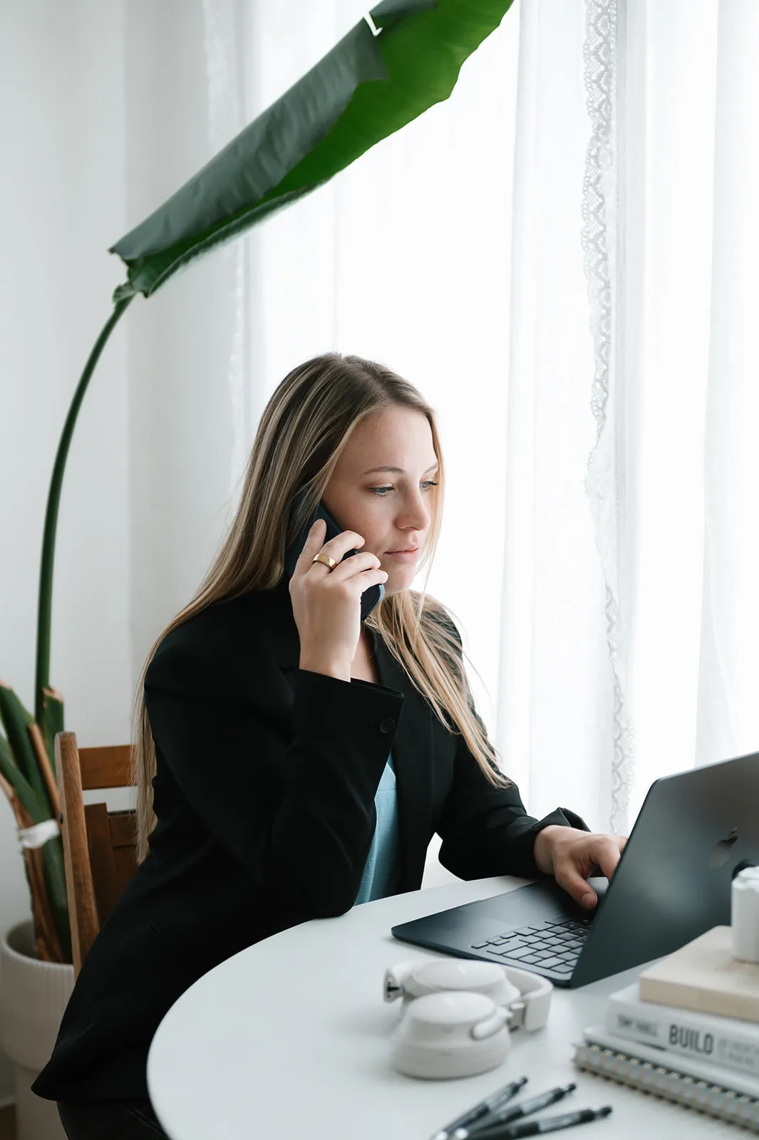 Brooke Kennison on a phone call while working at her laptop