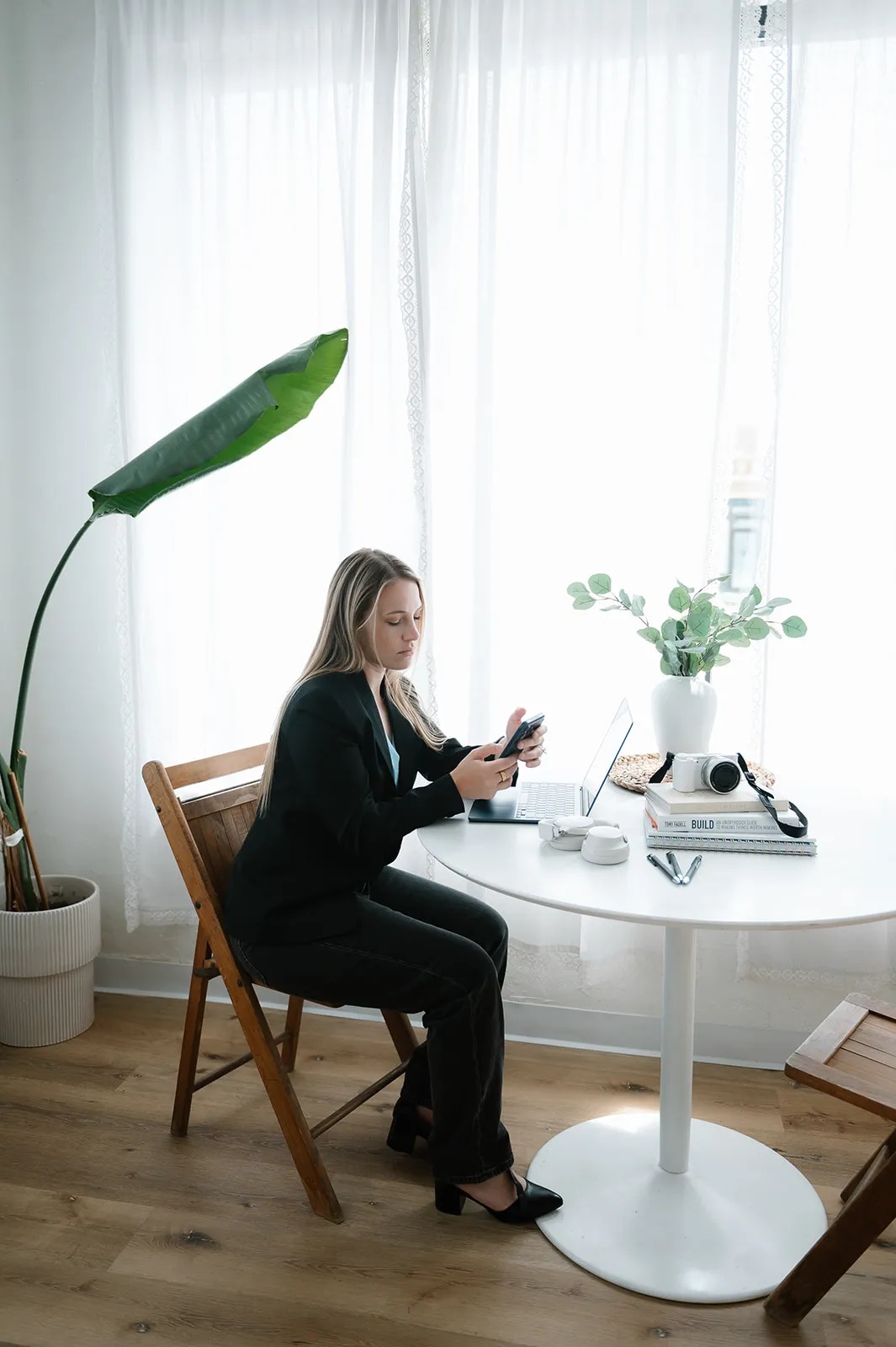 Brooke Kennison taking a call at her desk in the At The Meridian studio